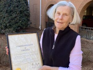 Leslie Bowie holding her framed certificate.